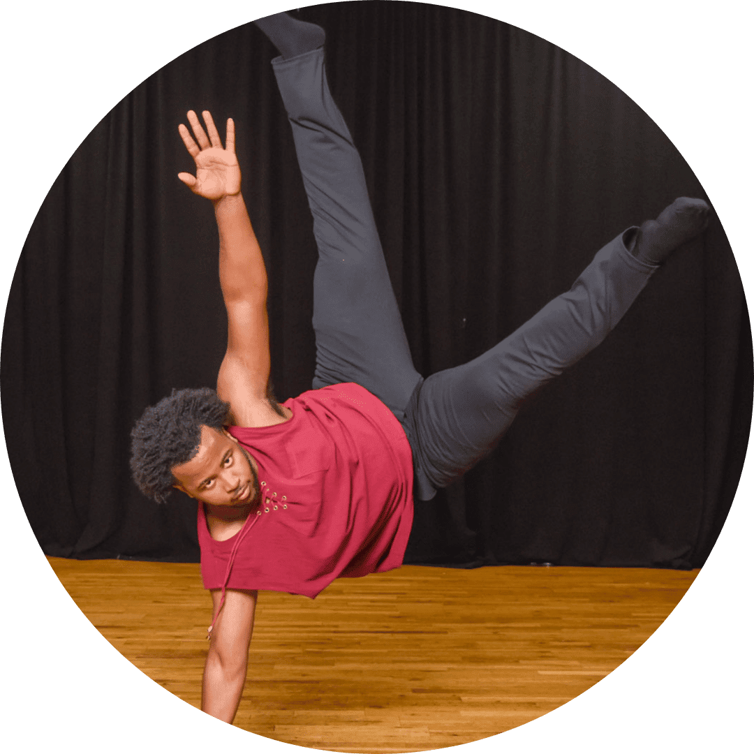 A man performing a handstand on a vibrant dance floor, showcasing his impressive balance and agility.